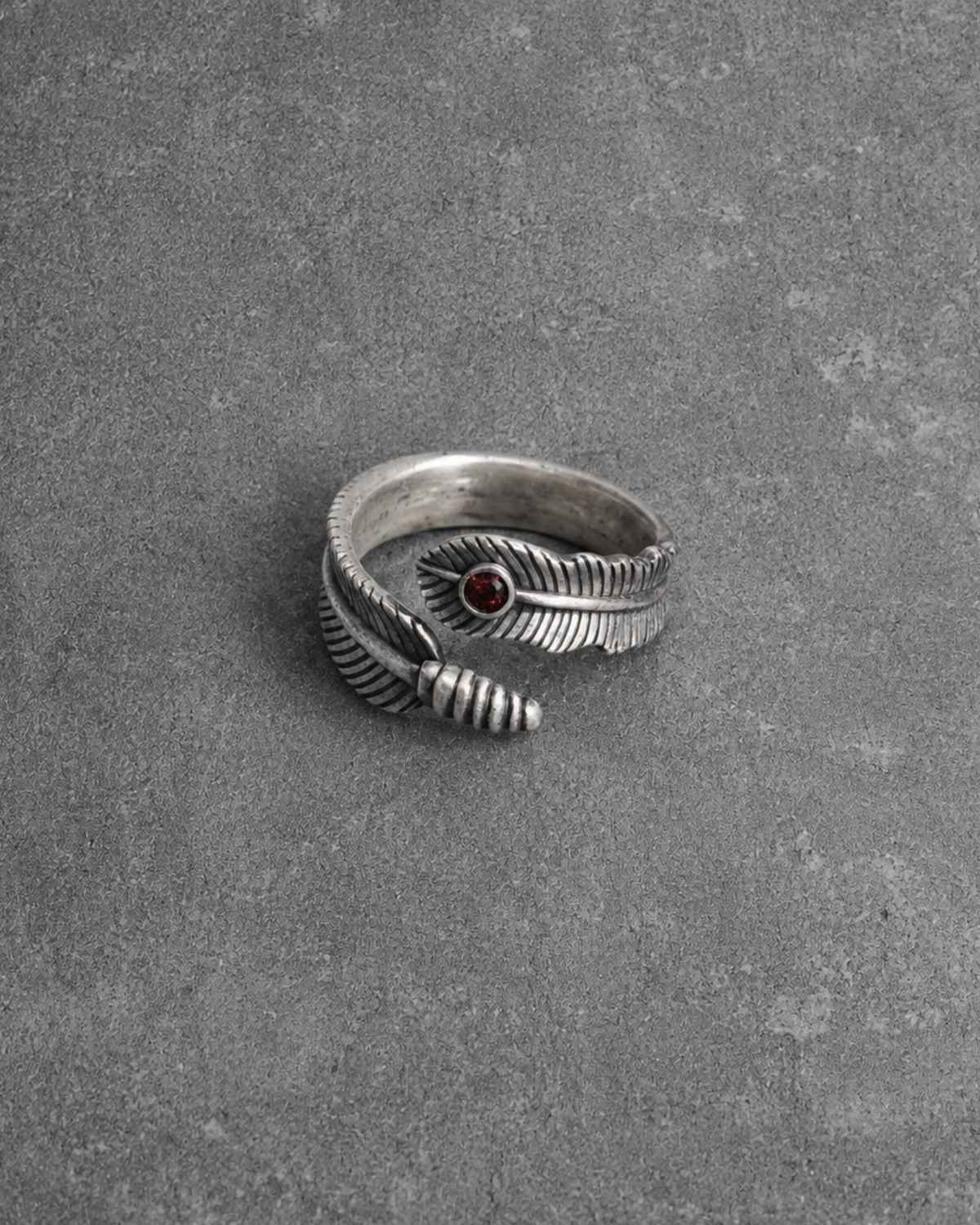 Feather ring with deep ruby red stone