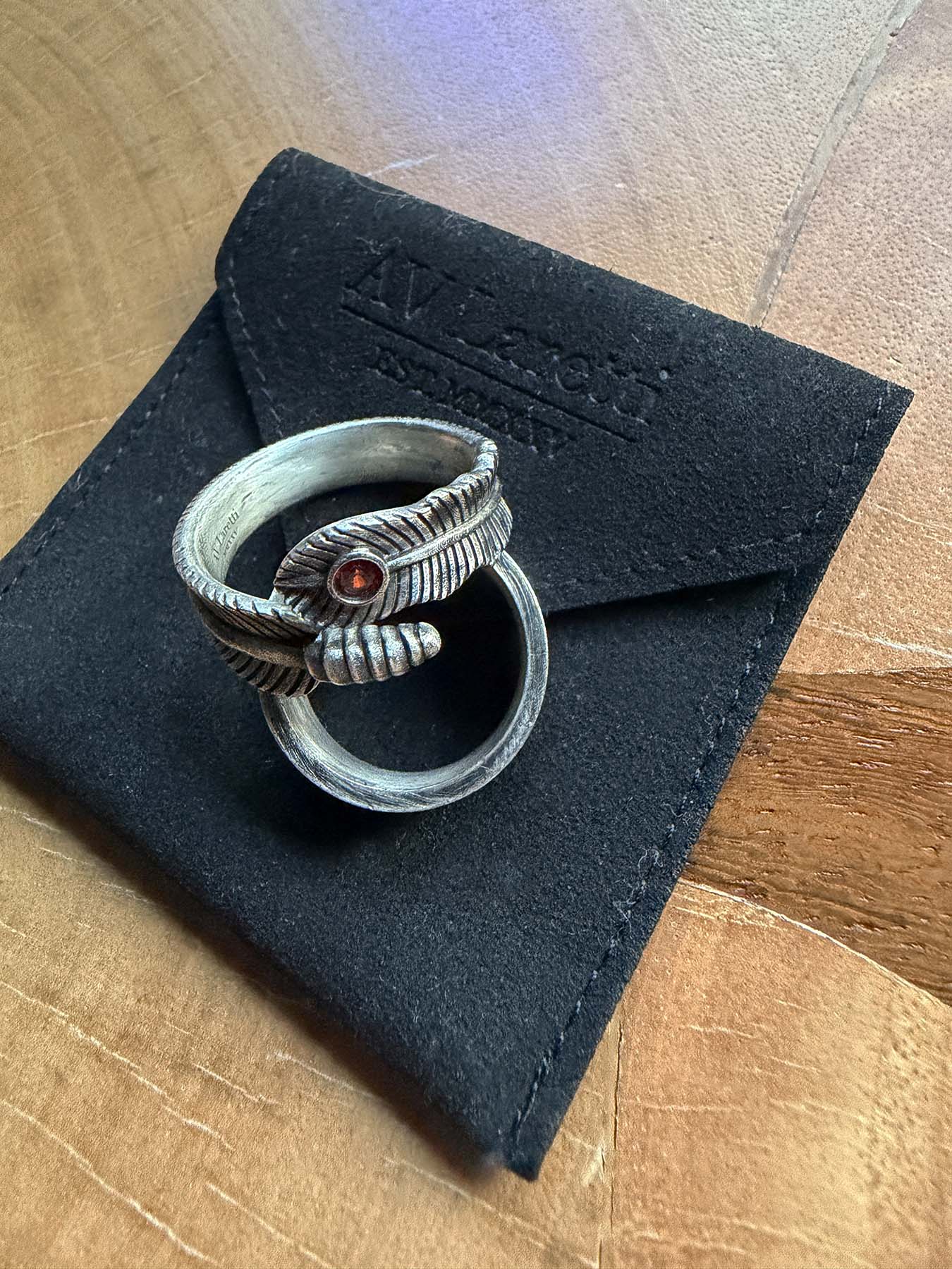 Feather ring with deep ruby red stone