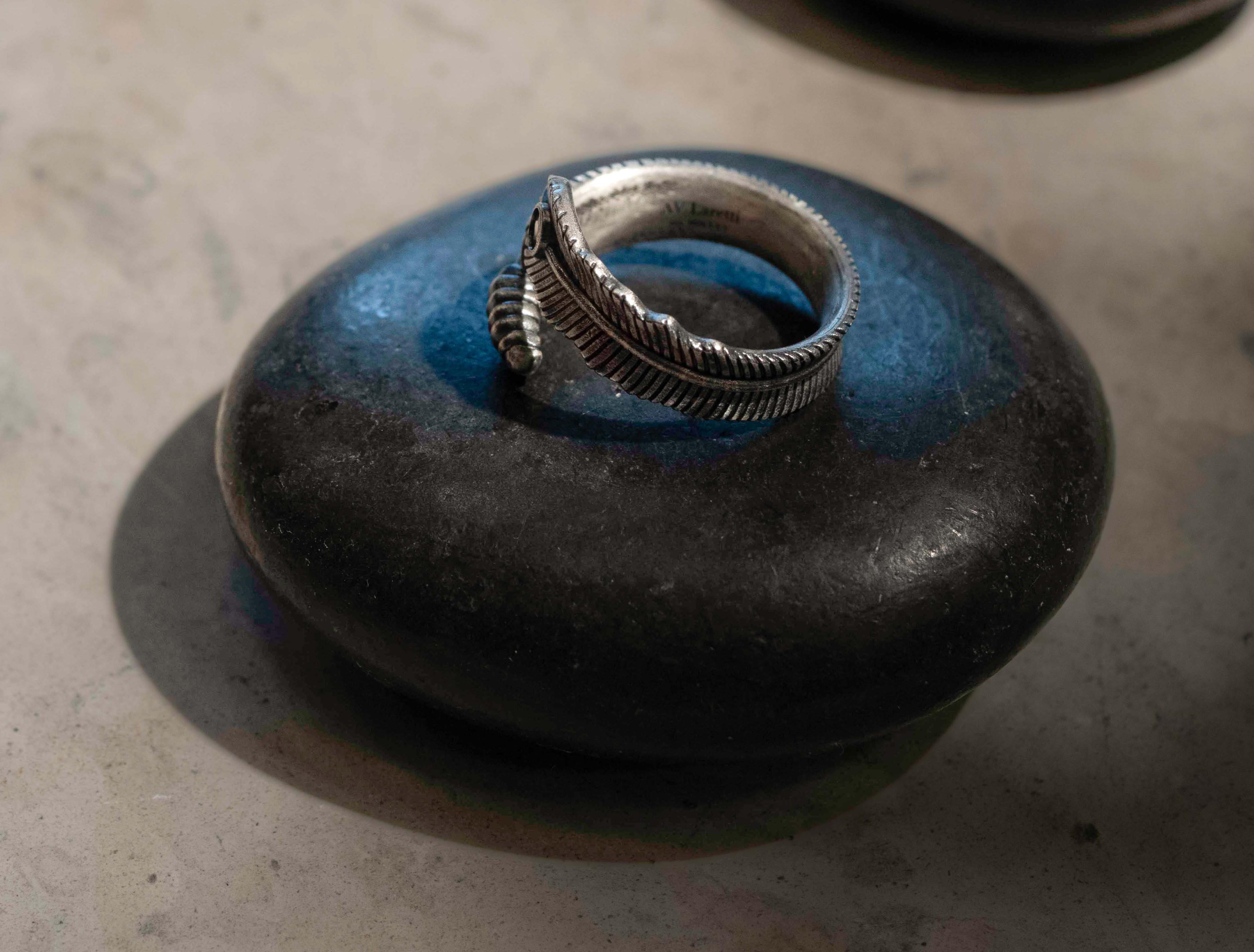 Feather ring with deep ruby red stone