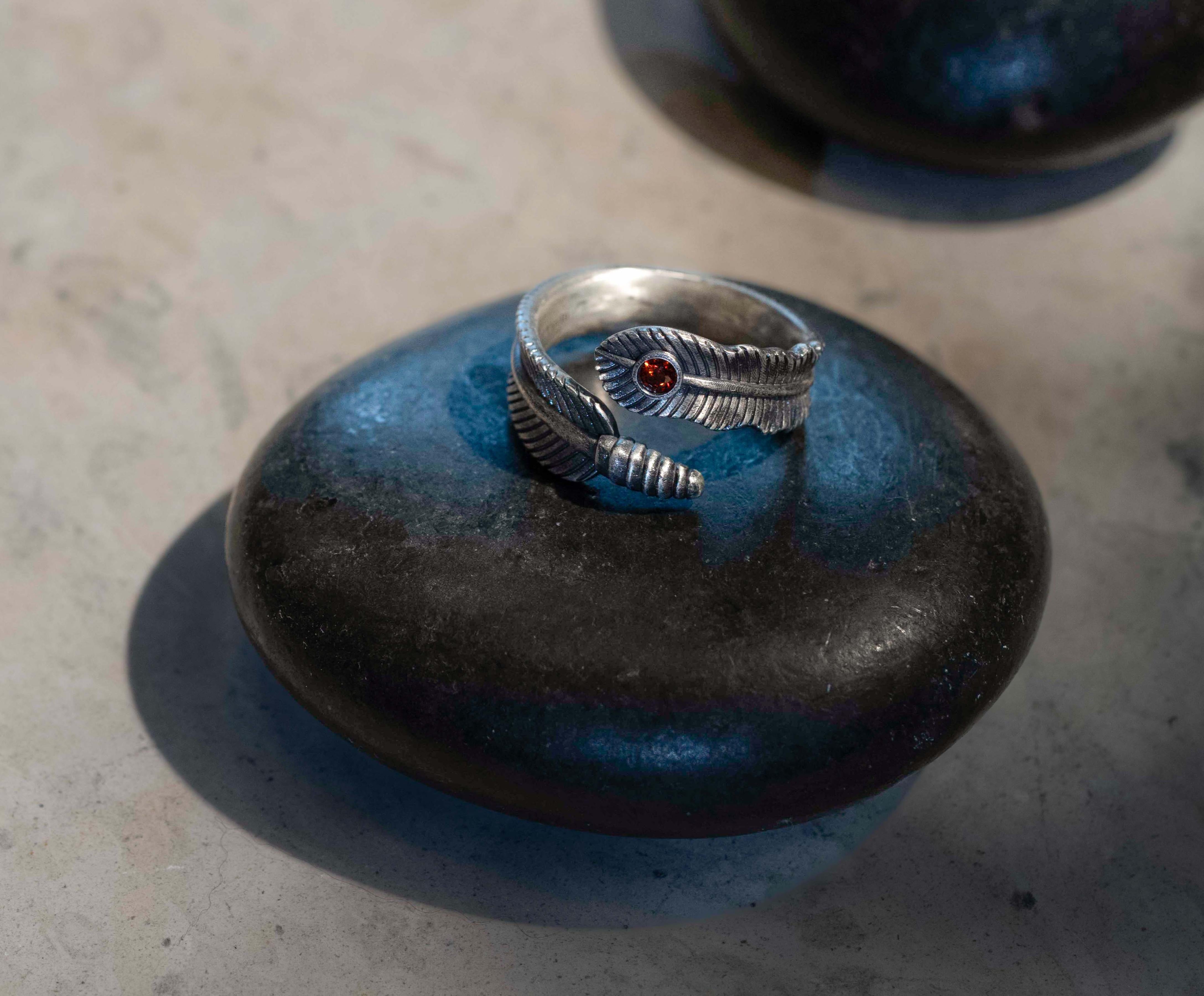 Feather ring with deep ruby red stone