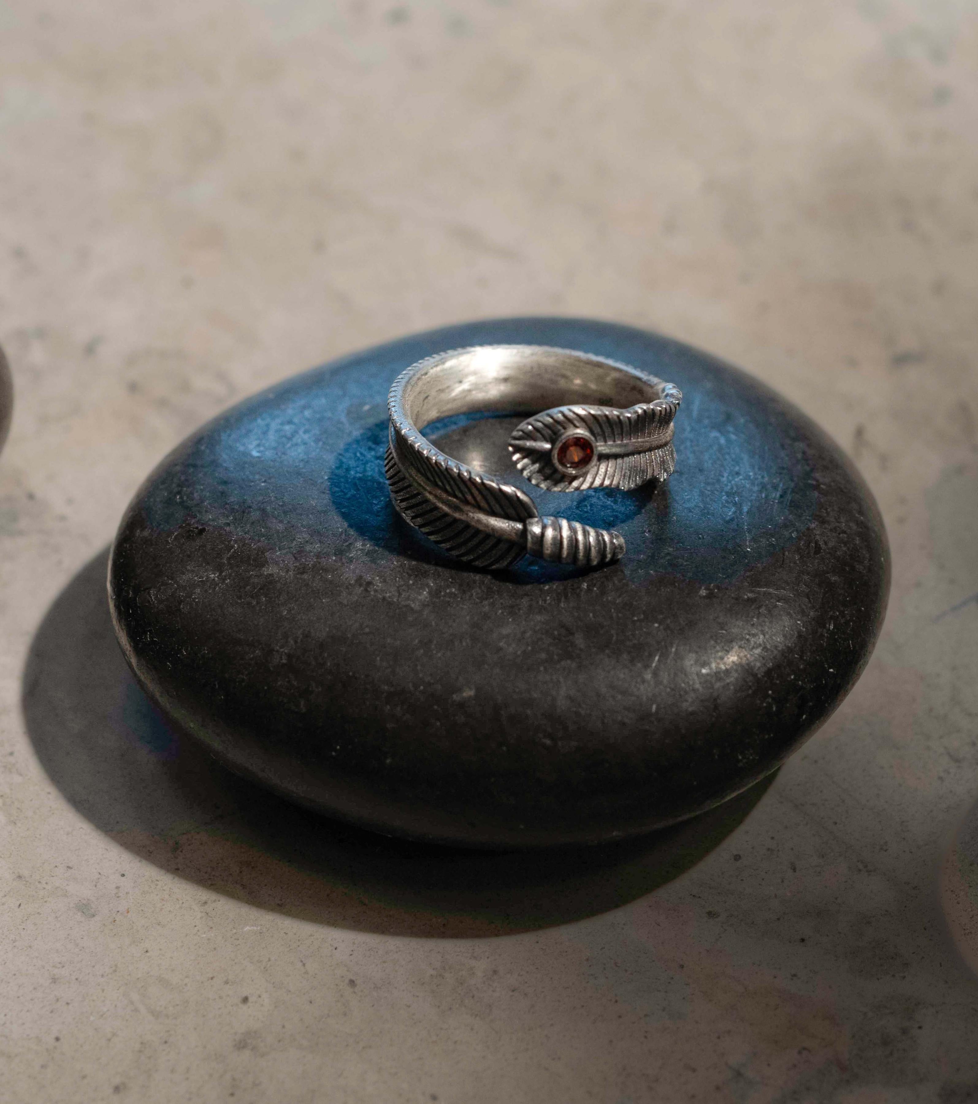 Feather ring with deep ruby red stone